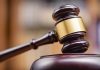 Gavel striking on a wooden sound block