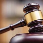 Gavel striking on a wooden sound block