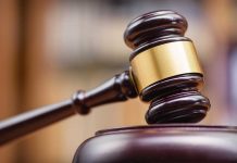 Gavel striking on a wooden sound block