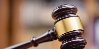 Gavel striking on a wooden sound block