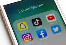 Phone showing social media app icons Snapchat TikTok YouTube