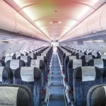 Empty airplane cabin with rows of seats