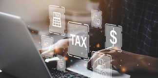 Person typing on laptop with tax-related icons displayed