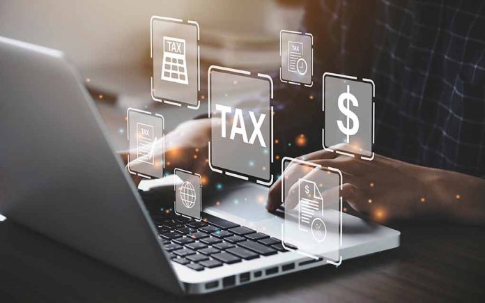 2018230646 featured image Person typing on laptop with tax-related icons displayed
