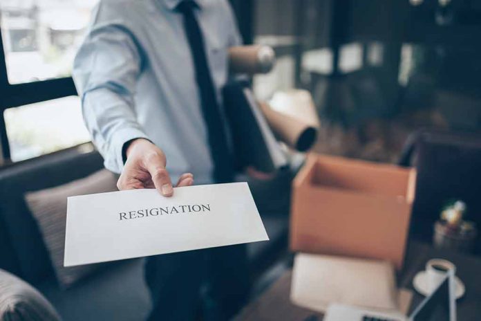 2022335198 featured image Person handing over a resignation letter.