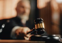 Judge holding gavel in a courtroom setting