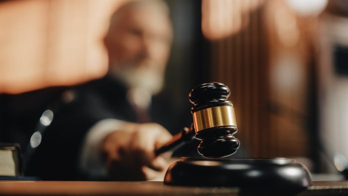 2056414424 featured image Judge holding gavel in a courtroom setting