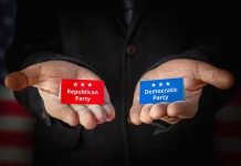 Hands holding Republican and Democratic Party cards