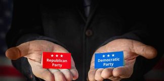 Hands holding Republican and Democratic Party cards