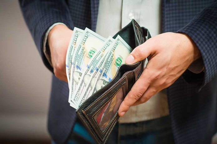 253526959 featured image Person holding wallet full of hundred dollar bills