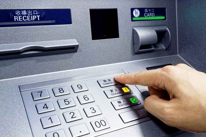260643578 featured image Person pressing button on an ATM keypad.