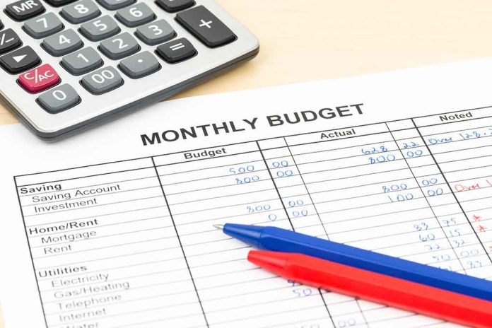 296028026 featured image Calculator and pens on monthly budget sheet