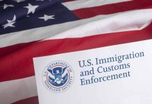 US flag behind Homeland Security document with logo