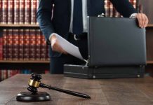 Gavel and person opening briefcase in law office