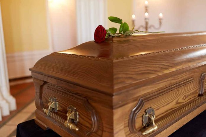 741689236 featured image Wooden coffin with red rose on top