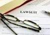 Lawsuit document with glasses pen and book