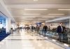 People walking through a busy airport terminal