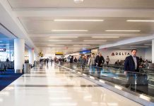 People walking through a busy airport terminal