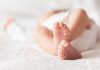 Close-up of baby feet lying on blanket