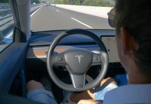 Person using autopilot in Tesla on highway.