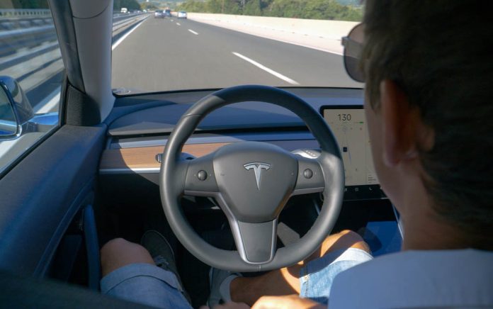 172510537 featured image Person using autopilot in Tesla on highway.