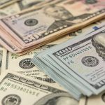 Stacks of various U.S. dollar bills