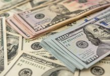 Stacks of various U.S. dollar bills