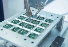 Robotic arm assembling electronic circuit boards in production