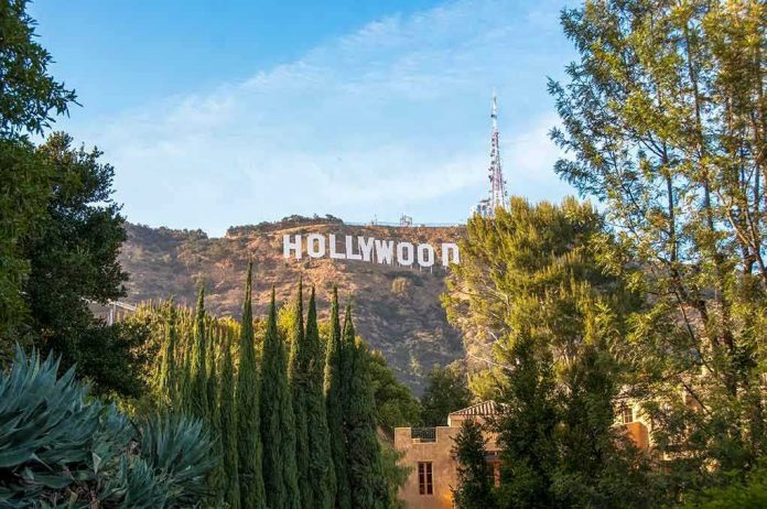 Hollywood sign on hill surrounded by trees and buildings