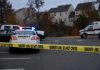 Sheriff line tape blocking scene with police and ambulance