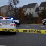 Sheriff line tape blocking scene with police and ambulance