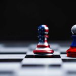 Two chess pawns painted as American and Russian flags