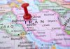 Red pushpin marking Iran on a map