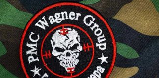 PMC Wagner Group patch on camouflage background
