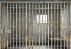 Empty rusty prison cell with a small window