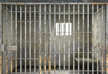 Empty rusty prison cell with a small window