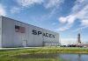 SpaceX building with American flag and launch pad
