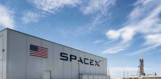 SpaceX building with American flag and launch pad