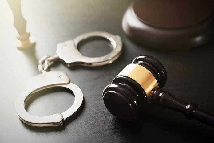 1921373279 Handcuffs and judge's gavel on the table