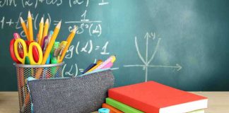 A collection of school supplies including notebooks, a pencil case, and writing instruments on a desk