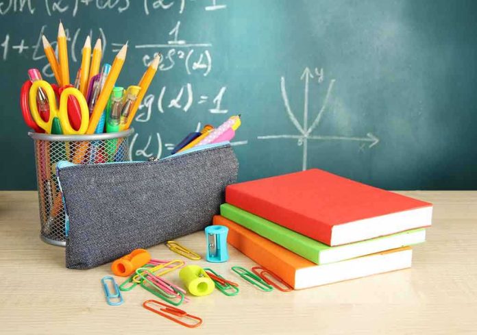 A collection of school supplies including notebooks, a pencil case, and writing instruments on a desk