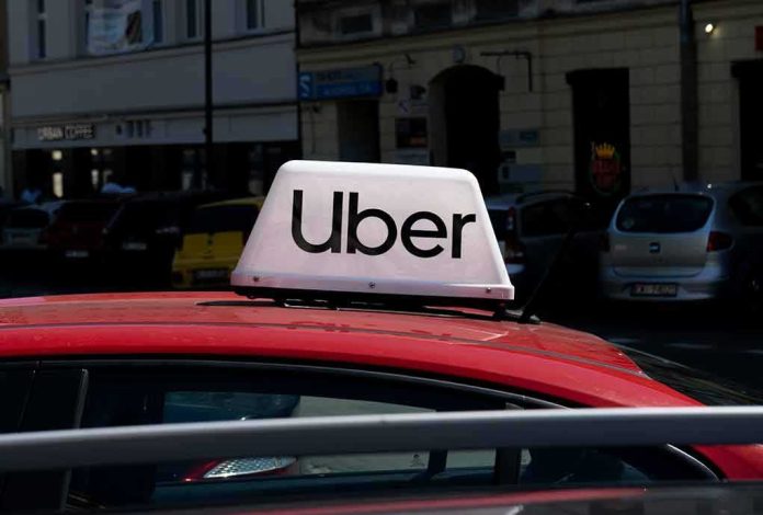 shutterstock_2352380579.jpg Uber sign on top of a red car in an urban setting
