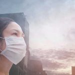 Person wearing a mask in a cityscape background
