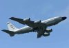 Military aircraft flying in clear blue sky.