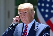 Trump FIRES Entire Dept—No Warning, No Mercy Man in a suit adjusting an earpiece.