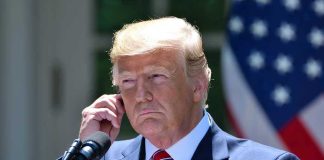 Trump FIRES Entire Dept—No Warning, No Mercy Man in a suit adjusting an earpiece.