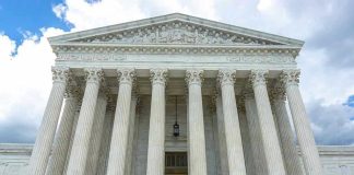 Trump Sends SCOTUS Petition – Requests Approval Building with columns under a cloudy sky.