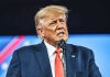 Trump WIPES Student Debt – Biden 2.0? Man in suit speaking at a microphone.
