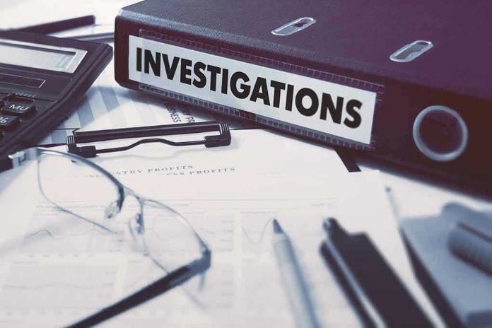 377375638 Documents and binder labeled Investigations on desk.
