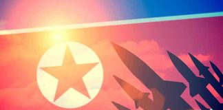 N.Korea FIRES Missile as Trump ARRIVES – Calculated! North Korean flag with missile silhouettes.